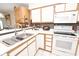Well-lit kitchen with stainless steel sink, white appliances, and neutral countertops at 9550 Dunes Gable Dr. # F, Myrtle Beach, SC 29572