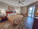 Bedroom with updated wood floors, balcony access, and two chairs at 9994 Beach Club Dr. # 205, Myrtle Beach, SC 29572