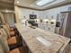 A modern kitchen features granite countertops and stylish bar seating at 9994 Beach Club Dr. # 205, Myrtle Beach, SC 29572