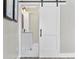 Bathroom with white barn door, modern vanity, and marble flooring at 11 Valencia Circle, Myrtle Beach, SC 29572