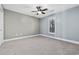 Bright bedroom with ceiling fan and large window at 11 Valencia Circle, Myrtle Beach, SC 29572