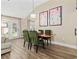 Bright dining area with hardwood floors and stylish green chairs at 11 Valencia Circle, Myrtle Beach, SC 29572