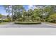 Community entrance with lush landscaping and circular driveway at 11 Valencia Circle, Myrtle Beach, SC 29572