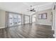 Spacious living area featuring hardwood floors, plantation shutters, and a ceiling fan at 11 Valencia Circle, Myrtle Beach, SC 29572