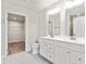 Double vanity bathroom with white cabinets and gray tile floors at 241 Bent Green Ct. # 64A, Murrells Inlet, SC 29576