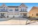 Two-story townhome with gray siding, two-car garage, and a brick facade at 241 Bent Green Ct. # 64A, Murrells Inlet, SC 29576