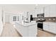 Modern kitchen with white cabinets, quartz countertops, and stainless steel appliances at 241 Bent Green Ct. # 64A, Murrells Inlet, SC 29576