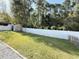 View of the backyard, with a white fence, shed, and green grass at 2549 Sugar Creek Ct., Myrtle Beach, SC 29579