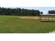 Community baseball field with green grass, baseball diamond, and sheltered bench at 2549 Sugar Creek Ct., Myrtle Beach, SC 29579