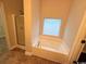 Bright bathroom features a large soaking tub and a glass block window at 2549 Sugar Creek Ct., Myrtle Beach, SC 29579