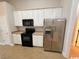 Efficient kitchen with white cabinets, stainless steel appliances, and tile flooring at 2549 Sugar Creek Ct., Myrtle Beach, SC 29579