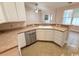 Kitchen featuring a stainless steel dishwasher, white cabinets, and tile floors at 2549 Sugar Creek Ct., Myrtle Beach, SC 29579