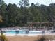 Community outdoor pool with lounge chairs and a pergola in the background at 2549 Sugar Creek Ct., Myrtle Beach, SC 29579