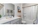 Well-lit bathroom with a combo shower and bathtub, a large vanity, and elegant fixtures at 318 Cheerful Way, Little River, SC 29566
