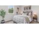 Cozy bedroom featuring a large window for natural light and a stylish bed with decorative pillows and artwork at 318 Cheerful Way, Little River, SC 29566