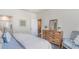 Cozy bedroom with an ensuite bathroom and a rustic wooden dresser at 318 Cheerful Way, Little River, SC 29566