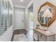 Inviting entryway with wood-look floors, decorative mirror, console table and neutral wall paint at 318 Cheerful Way, Little River, SC 29566