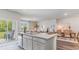 Open concept kitchen flowing into the living and dining areas, featuring granite countertops and ample cabinet space at 318 Cheerful Way, Little River, SC 29566