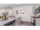 Stylish kitchen with gray cabinets, stainless steel appliances, granite countertops, and modern fixtures at 318 Cheerful Way, Little River, SC 29566