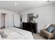 Spacious bedroom with dresser, armchair, and neutral color scheme at 3851 Lady Bug Dr., Shallotte, NC 28470