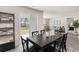 Dining area with sliding door to backyard and black dining table at 3851 Lady Bug Dr., Shallotte, NC 28470