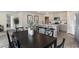 Dining area with black table, gray flooring, and view into kitchen at 3851 Lady Bug Dr., Shallotte, NC 28470