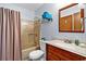 Standard bathroom with a shower and tub combo and vanity with traditional style wood finish at 1930 Bent Grass Dr. # 40K, Surfside Beach, SC 29575
