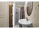 Cozy bathroom with a pedestal sink and shower with a curtain; features a decorative mirror at 1930 Bent Grass Dr. # 40K, Surfside Beach, SC 29575