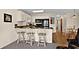 Well-lit kitchen with white cabinets, black appliances, and breakfast bar seating at 1930 Bent Grass Dr. # 40K, Surfside Beach, SC 29575