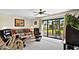 Comfortable living room with ceiling fan and sliding glass doors leading to an outdoor view at 1930 Bent Grass Dr. # 40K, Surfside Beach, SC 29575