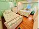 Bright bedroom with two twin beds, light green walls, and matching llama-themed bedding at 6001 - 5410 S Kings Hwy., Myrtle Beach, SC 29575
