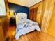 Charming bedroom with wood paneling, queen bed, and blue accent wall at 6001 - 5410 S Kings Hwy., Myrtle Beach, SC 29575