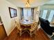 Cozy dining area featuring wood floors, a round table with six chairs, and bright window at 6001 - 5410 S Kings Hwy., Myrtle Beach, SC 29575