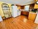 Functional kitchen with classic wood cabinets, white appliances, and durable wood-look flooring at 6001 - 5410 S Kings Hwy., Myrtle Beach, SC 29575