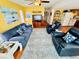 Cozy living room features comfortable blue seating, a ceiling fan, and wood-look flooring at 6001 - 5410 S Kings Hwy., Myrtle Beach, SC 29575