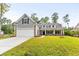 Two-story home with gray siding, white garage door, and landscaped lawn at 790 Caines Landing Rd., Conway, SC 29526