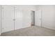 Bedroom with double door closet and open doorway, showing neutral carpet and ample lighting at 1124 Cypress Shoal Dr., Conway, SC 29526