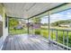 Front porch with wooden floor and railings, overlooking yard at 1861 Jenerette St., Mullins, SC 29574