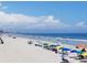 Expansive beach vista with colorful umbrellas and a cityscape skyline in the distance at 1060 Log Cabin Rd., Loris, SC 29569