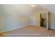 Spacious bedroom showcasing a slanted ceiling and neutral-colored walls and carpet at 1060 Log Cabin Rd., Loris, SC 29569