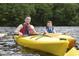 Personal and boy paddling together in yellow kayaks at 1060 Log Cabin Rd., Loris, SC 29569