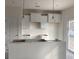 Bright, partially finished kitchen area with white cabinets, modern light fixtures and sliding glass doors at 1060 Log Cabin Rd., Loris, SC 29569