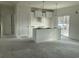 Bright, partially finished kitchen area with a center island, modern light fixtures and sliding glass doors at 1060 Log Cabin Rd., Loris, SC 29569