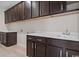 Laundry room with dark cabinets and a built in sink at 284 Starlit Way, Myrtle Beach, SC 29579