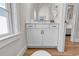 Bathroom features wooden floors, white cabinets and framed mirror at 4989 Salt Creek Ct., North Myrtle Beach, SC 29582