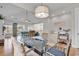 Open-concept dining room with a large table, modern chandelier, and views to the living area at 4989 Salt Creek Ct., North Myrtle Beach, SC 29582