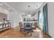 Elegant dining room with wood floors, an modern light fixture, and views into kitchen at 4989 Salt Creek Ct., North Myrtle Beach, SC 29582