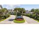 Inviting entrance to a well-maintained community with palm trees and colorful flowerbeds at 4989 Salt Creek Ct., North Myrtle Beach, SC 29582