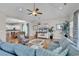 Comfortable living room with light-blue sofa, wicker chair, hardwood floors, and open to the kitchen at 4989 Salt Creek Ct., North Myrtle Beach, SC 29582