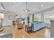 Bright living room featuring hardwood floors, a ceiling fan, and large windows for natural light at 4989 Salt Creek Ct., North Myrtle Beach, SC 29582